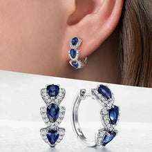 Boucles d'oreilles avec blason royal et pierres précieuses